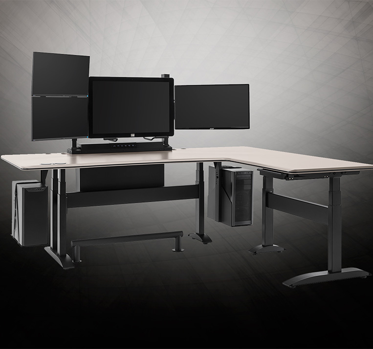 Two desks and a monitor stand are placed in a reading room optimized for ergonomic workstations